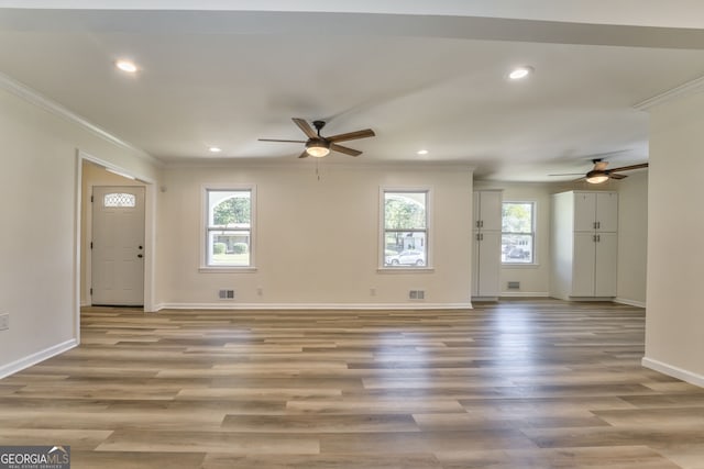 unfurnished living room featuring light hardwood / wood-style floors, ceiling fan, and a wealth of natural light