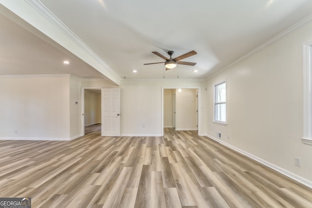 spare room featuring light hardwood / wood-style flooring, crown molding, and ceiling fan