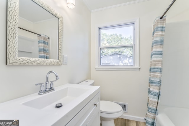 full bathroom with hardwood / wood-style flooring, toilet, shower / bath combination with curtain, crown molding, and vanity