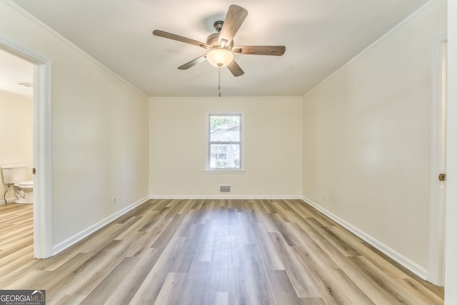 empty room with crown molding, light wood-type flooring, and ceiling fan