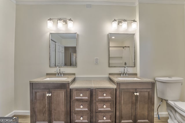 bathroom featuring vanity, toilet, ornamental molding, and wood-type flooring