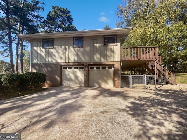 front facade with a garage and a deck