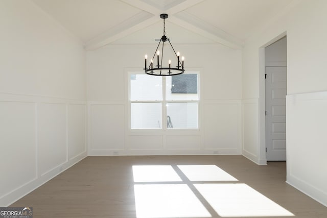 unfurnished dining area featuring hardwood / wood-style flooring, a notable chandelier, crown molding, and beamed ceiling