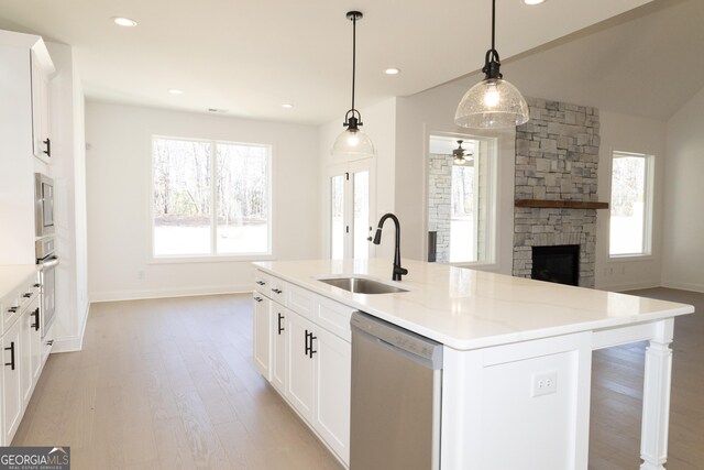 kitchen featuring a center island with sink, plenty of natural light, sink, and appliances with stainless steel finishes