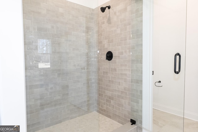 bathroom with tile patterned flooring and a shower with shower door