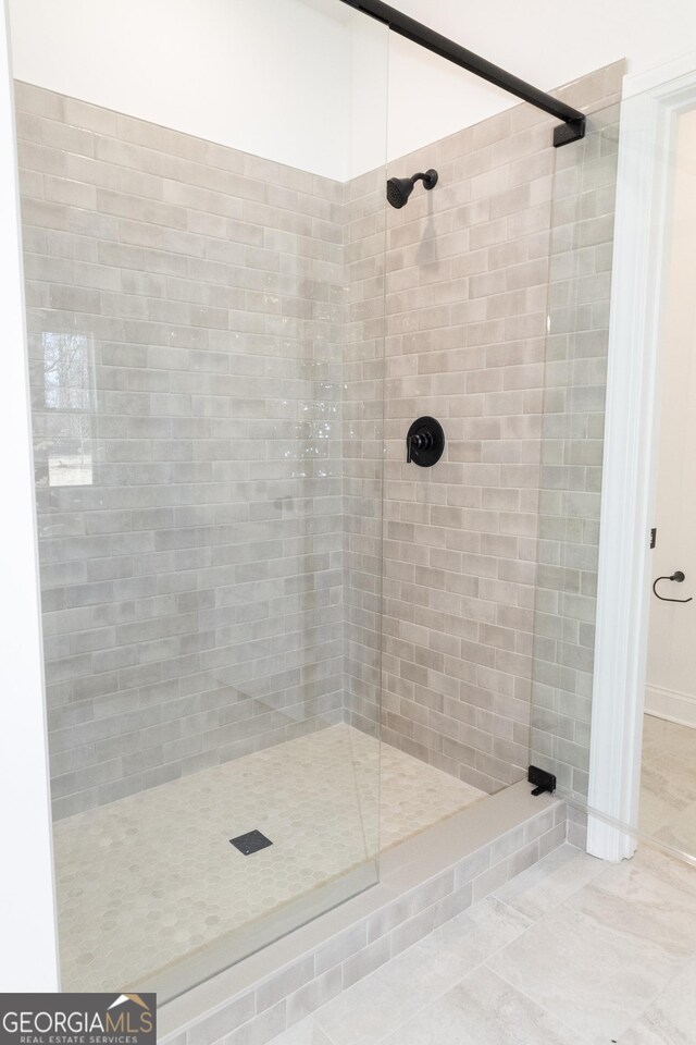 bathroom with a tile shower