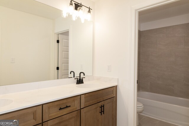 bathroom with tile patterned floors, vanity, and toilet