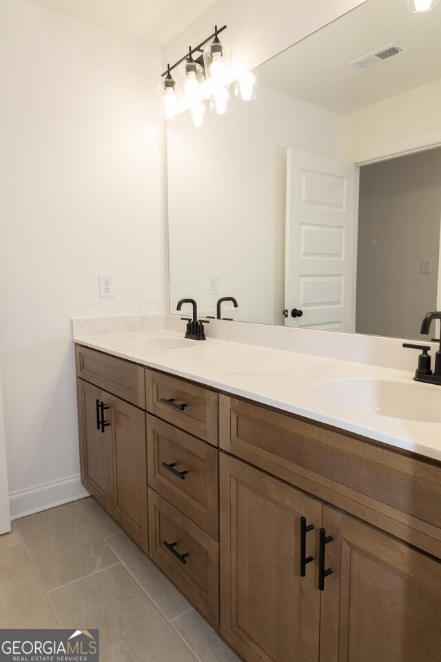 bathroom with tile patterned flooring and vanity