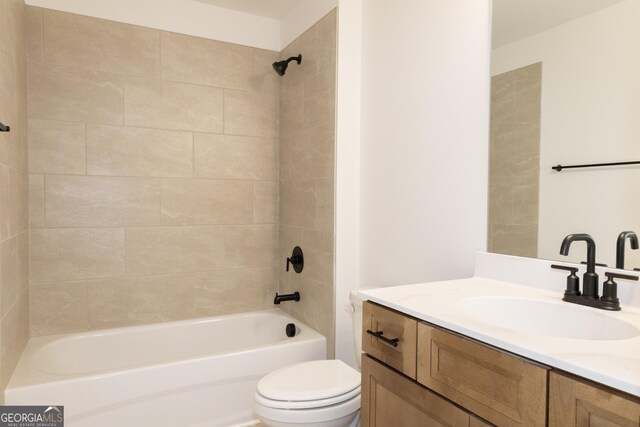 full bathroom with vanity, toilet, and tiled shower / bath