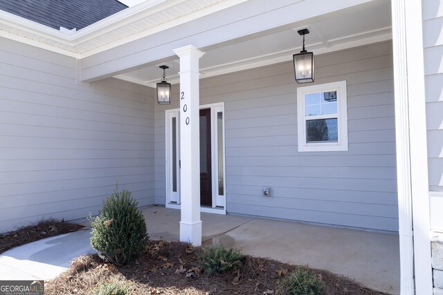 view of exterior entry with covered porch