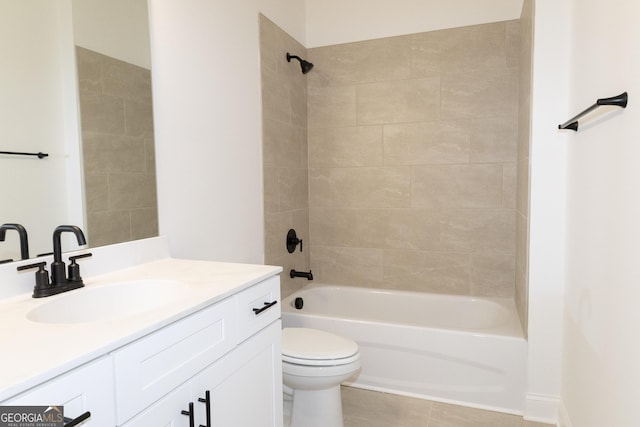 full bathroom featuring tile patterned flooring, tiled shower / bath combo, toilet, and vanity