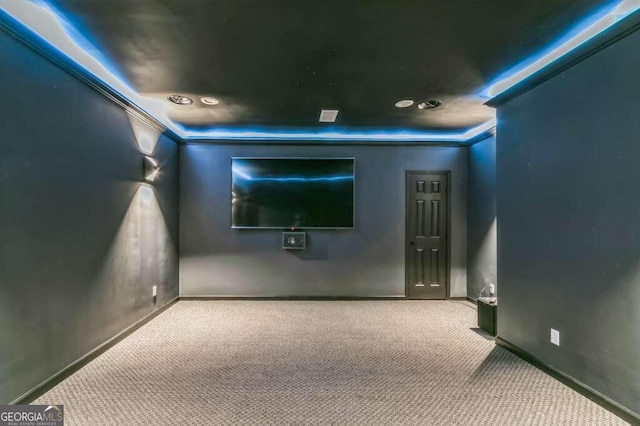 carpeted home theater with crown molding