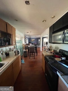 kitchen featuring sink, electric range, and dark hardwood / wood-style floors