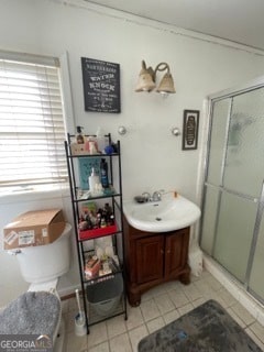 bathroom featuring vanity, tile patterned flooring, and walk in shower