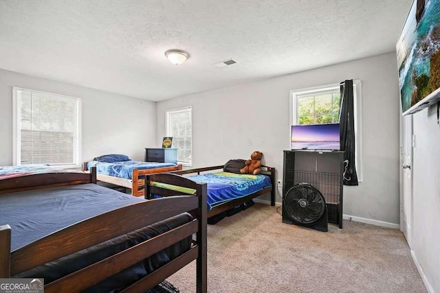 carpeted bedroom featuring a textured ceiling