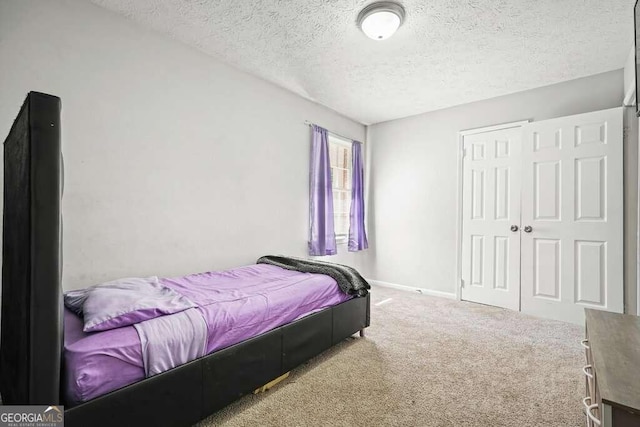 carpeted bedroom featuring a textured ceiling