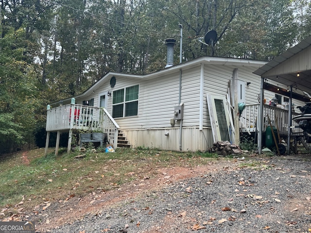 view of side of property with a wooden deck