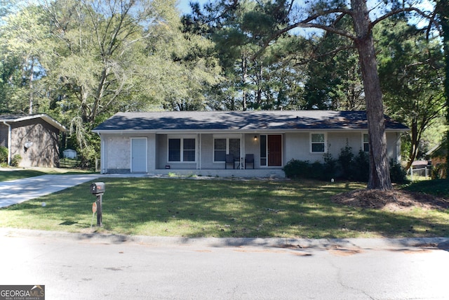 ranch-style house featuring a porch and a front lawn