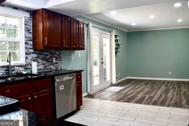 kitchen featuring light hardwood / wood-style floors, a healthy amount of sunlight, dishwasher, and crown molding