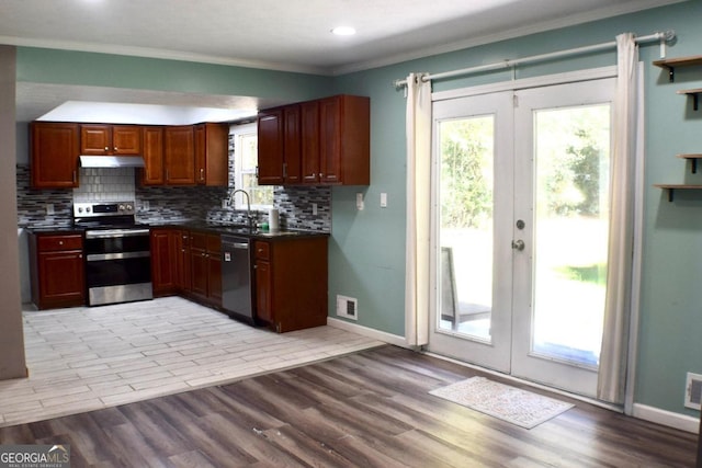 kitchen featuring appliances with stainless steel finishes, french doors, and light wood-type flooring