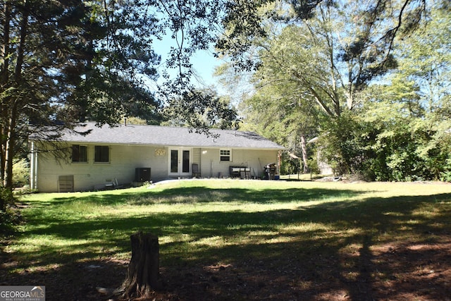 back of house with a patio area and a yard