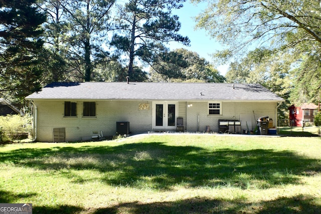 back of property with a yard, a patio area, and central air condition unit