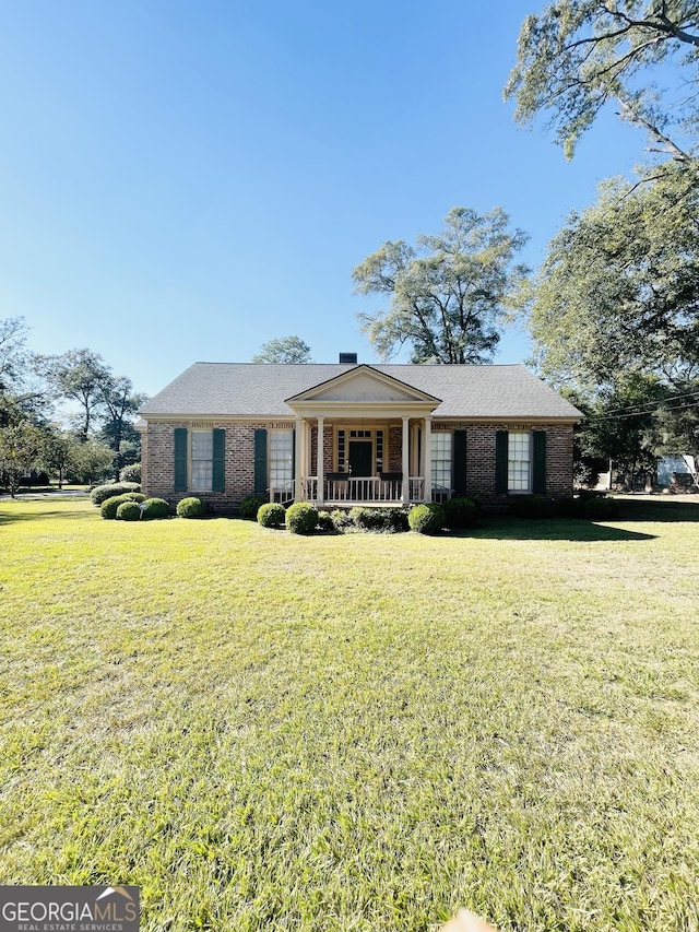 single story home with a porch and a front yard