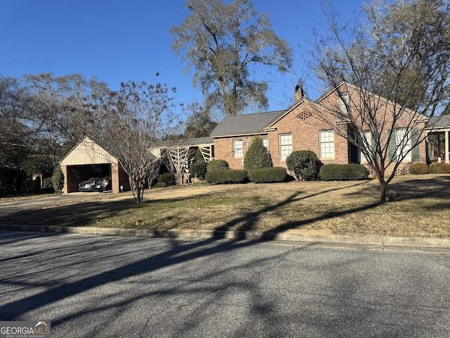 ranch-style house with a front lawn and a carport