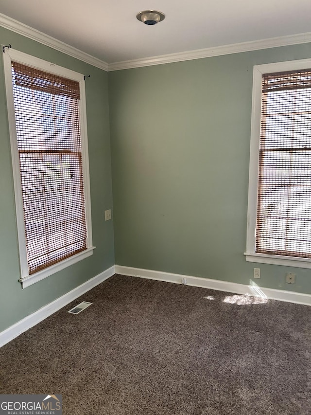 carpeted spare room featuring crown molding