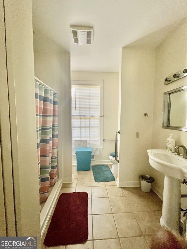 bathroom with tile patterned flooring, sink, toilet, and a shower with shower curtain