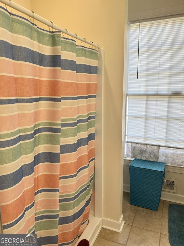 bathroom featuring a shower with curtain and tile patterned flooring