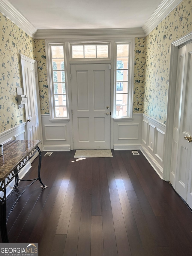 foyer entrance with ornamental molding, dark hardwood / wood-style floors, and a wealth of natural light