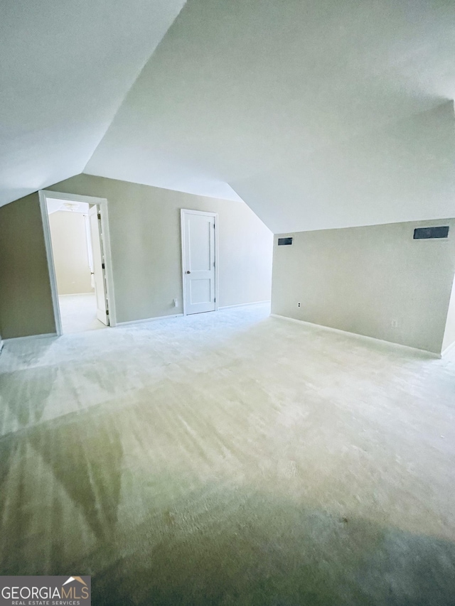 bonus room featuring lofted ceiling and carpet floors