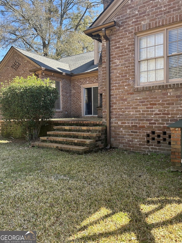 view of side of property with a yard