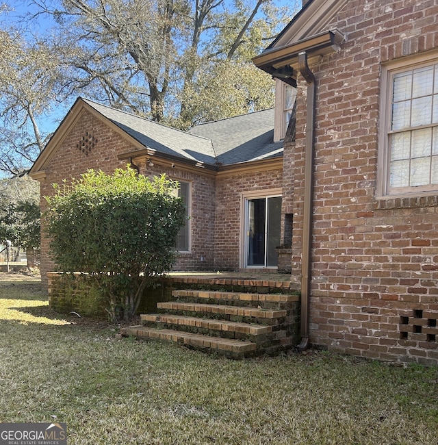 view of side of home with a yard