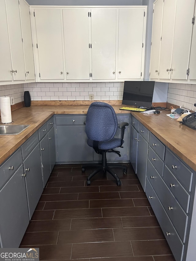 unfurnished office with built in desk and sink