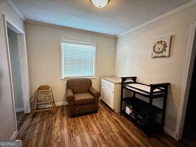 living area with ornamental molding and dark hardwood / wood-style flooring