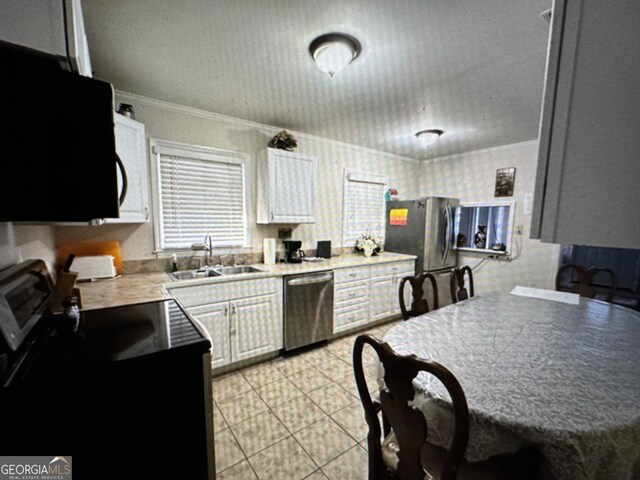 5859 8th Ave, Eastman, GA 31023 - kitchen featuring appliances with stainless steel finishes, a sink, crown molding, white cabinetry, and a textured ceiling