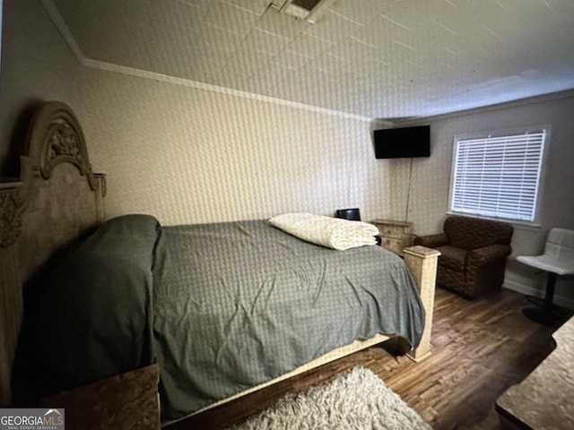 5859 8th Ave, Eastman, GA 31023 - bedroom featuring wood finished floors, crown molding, and baseboards