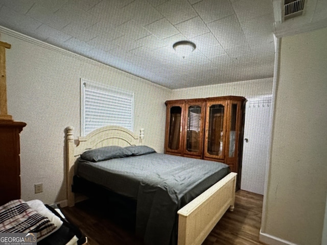 bedroom with dark wood-type flooring