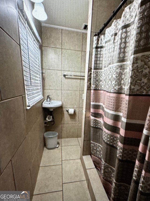 bathroom with tile patterned floors, tile walls, and a shower with curtain