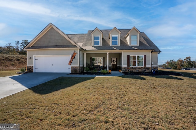 view of front facade featuring a front lawn, covered porch, and a garage