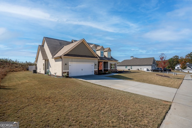 view of front of property with a front yard and a garage