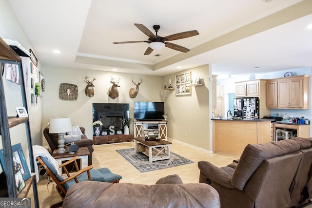 1410 Will Cox Rd, Waycross, GA 31503 - living room with a raised ceiling, a ceiling fan, recessed lighting, and light wood-style flooring