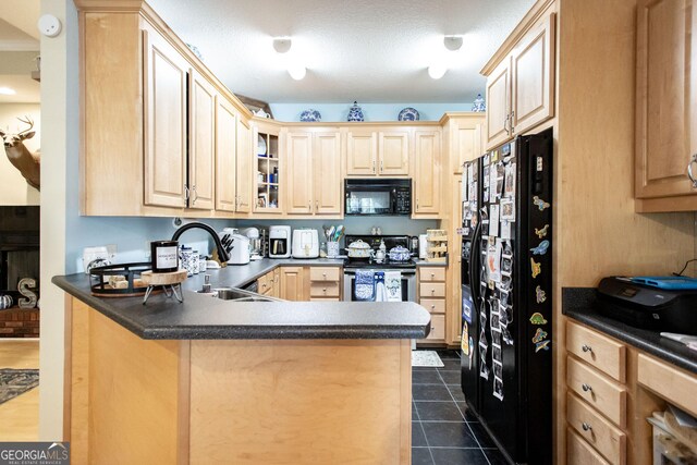 1410 Will Cox Rd, Waycross, GA 31503 - kitchen with a sink, light brown cabinetry, black appliances, and dark countertops