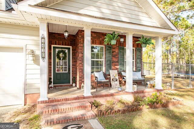 1410 Will Cox Rd, Waycross, GA 31503 - entrance to property with fence, covered porch, a garage, and brick siding
