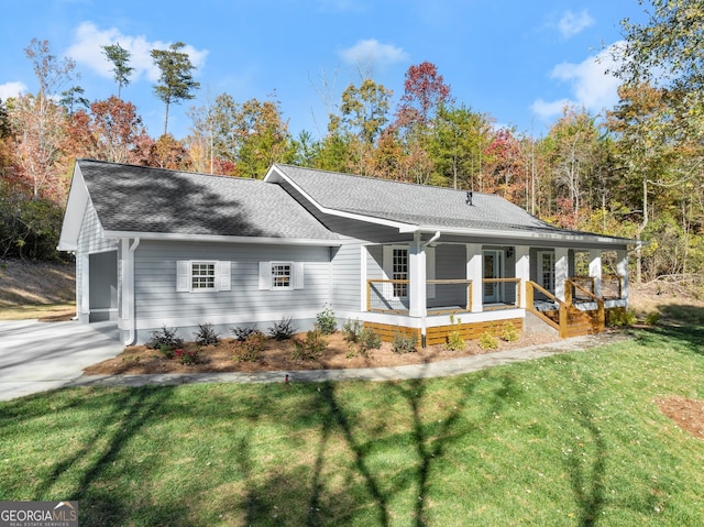 exterior space with covered porch, a front yard, and a garage