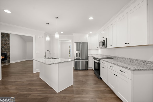 kitchen with appliances with stainless steel finishes, sink, decorative light fixtures, white cabinets, and dark wood-type flooring