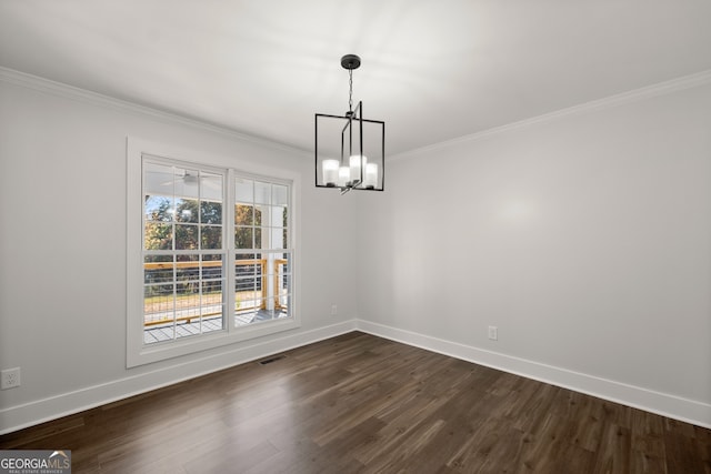 unfurnished dining area with an inviting chandelier, ornamental molding, and dark wood-type flooring