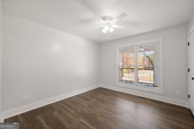 empty room featuring ceiling fan and dark hardwood / wood-style flooring